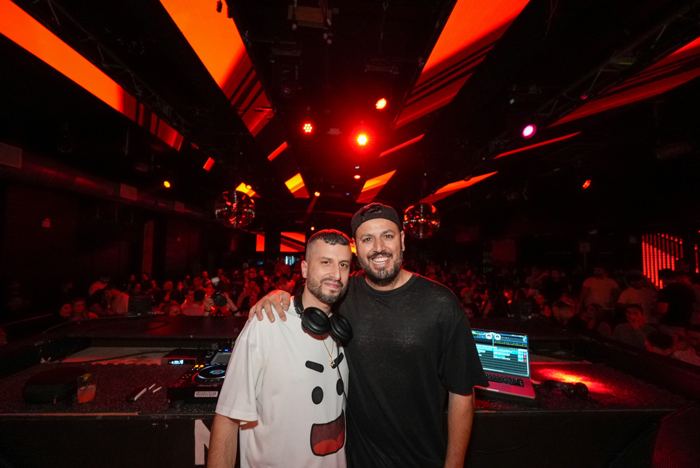 With a friend in a red-lit club