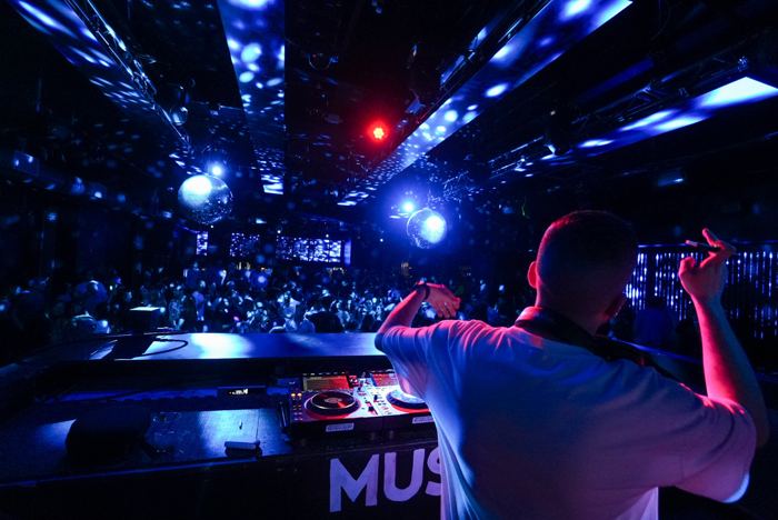 Arm up over a blue-lit club